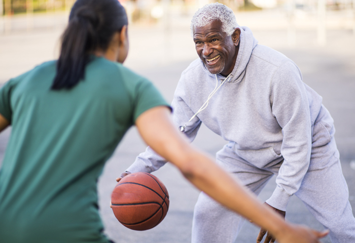 mature man playing basketball