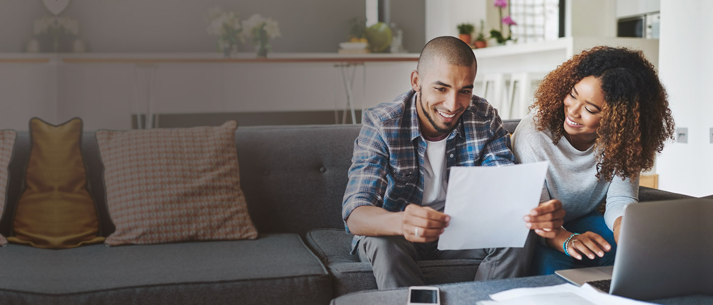 Husband and wife on their laptop applying for an ISA with Foresters