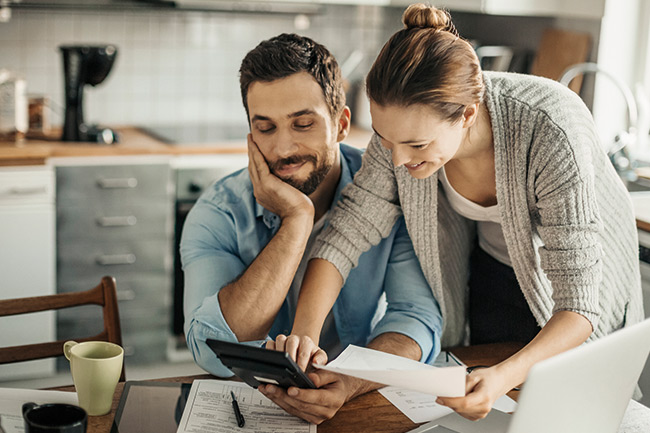 Couple looking on calculator