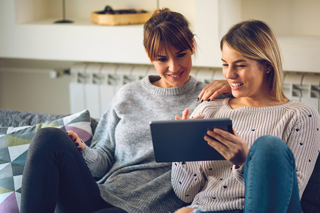Ladies sitting on sofa looking at ISAs