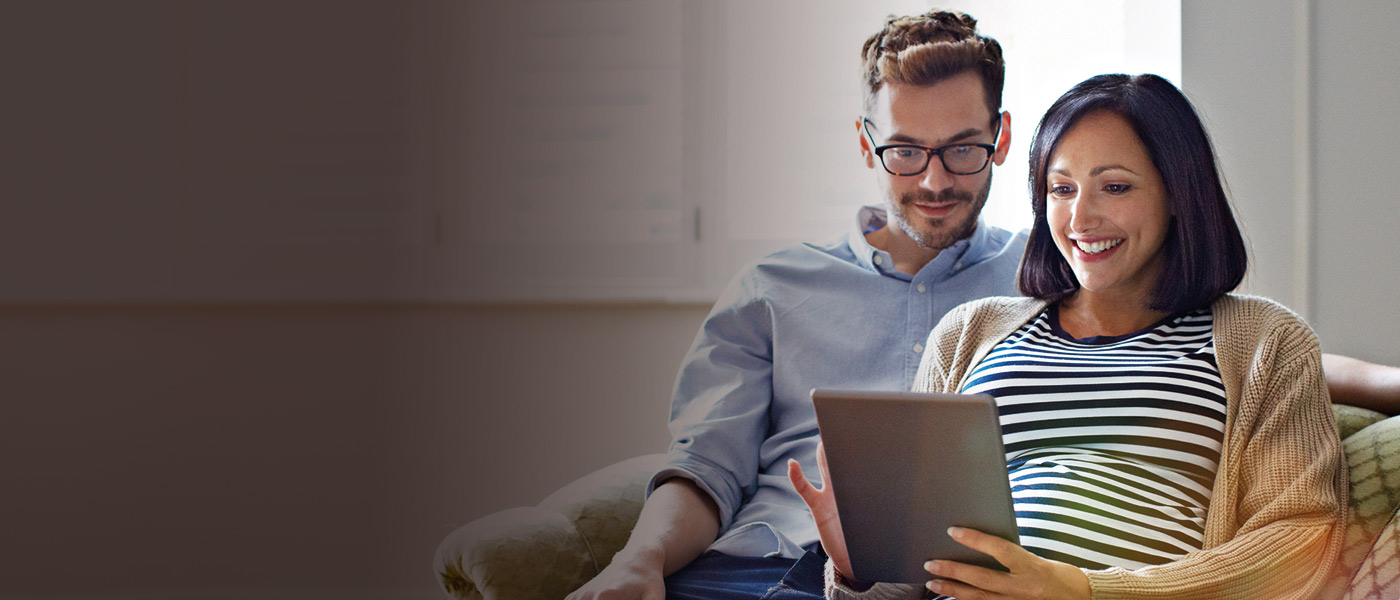 husband and wife on their tablet looking at a Foresters ISA