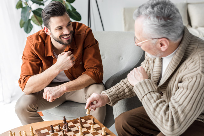 Father and son playing chess with a Foresters ISA