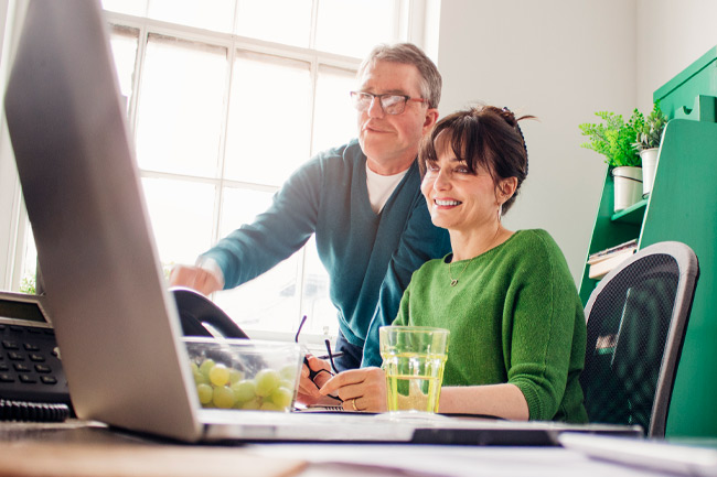 Couple on laptop exploring a Foresters ISA