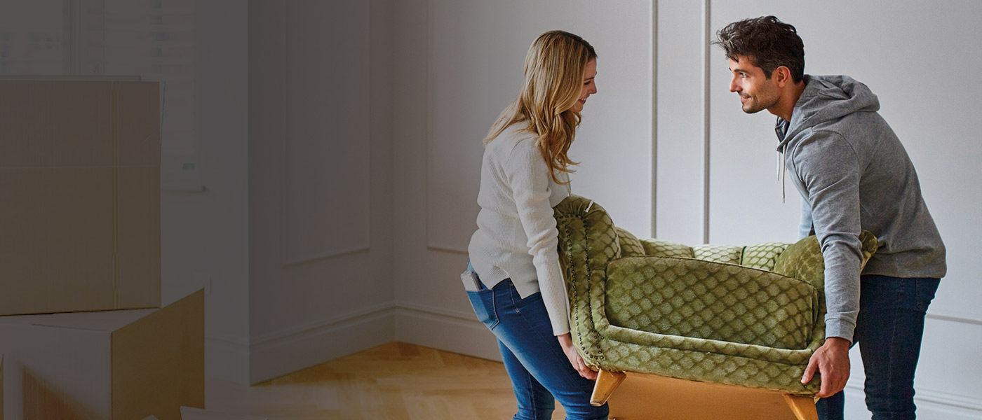 Lifetime ISA couple moving furniture into their first home