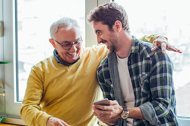 Happy father and son requesting a Financial Adviser on their mobile
