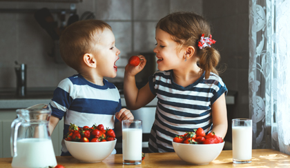 Happy children eating food who each have a Cash Junior ISA and Stocks and Shares Junior ISA