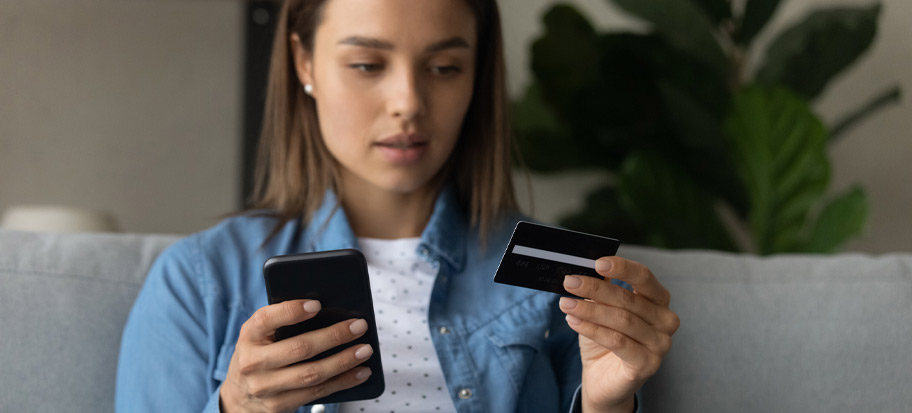 Young adult keeping safe online while entering card details on phone