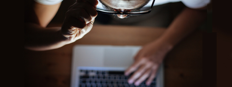Concerned man on computer reading a suspicious email