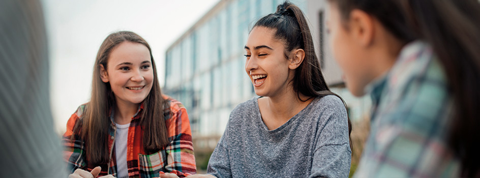 Teenagers at school talking about their Junior ISAs