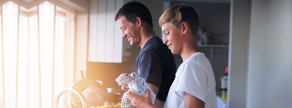 Father with his son washing up while talking about his Junior ISA