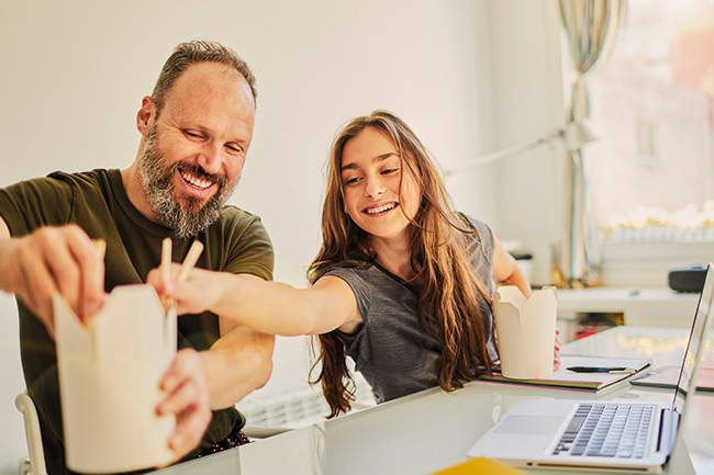 Happy father eating Chinese with daughter who has a Foresters Child Trust Fund