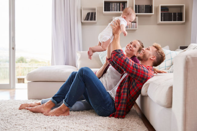 Happy parents with their baby who has a Foresters Junior ISA