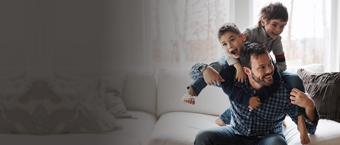 Father playing with his sons that have a Foresters Junior ISA