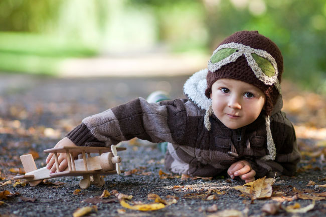 Little boy with a Junior ISA dressed as a pilot with toy plane