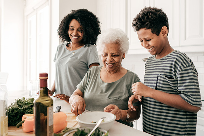 Grandmother, daughter and grandson cooking