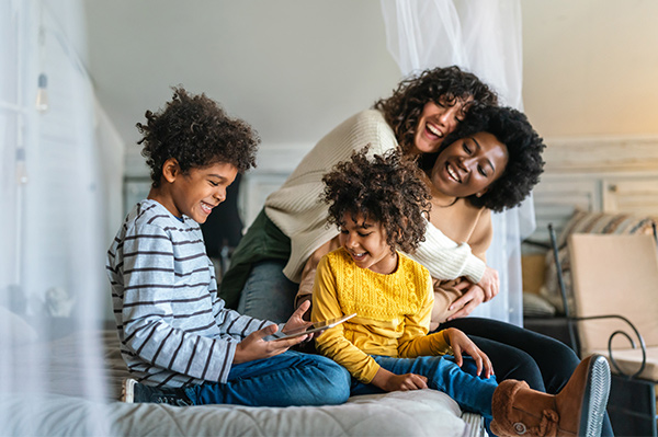black and white mothers and sons using their online MyPlans account with Foresters