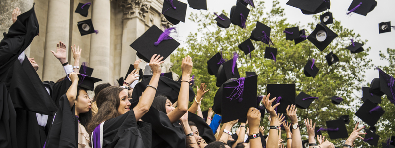 Students graduating throwing mortar boards