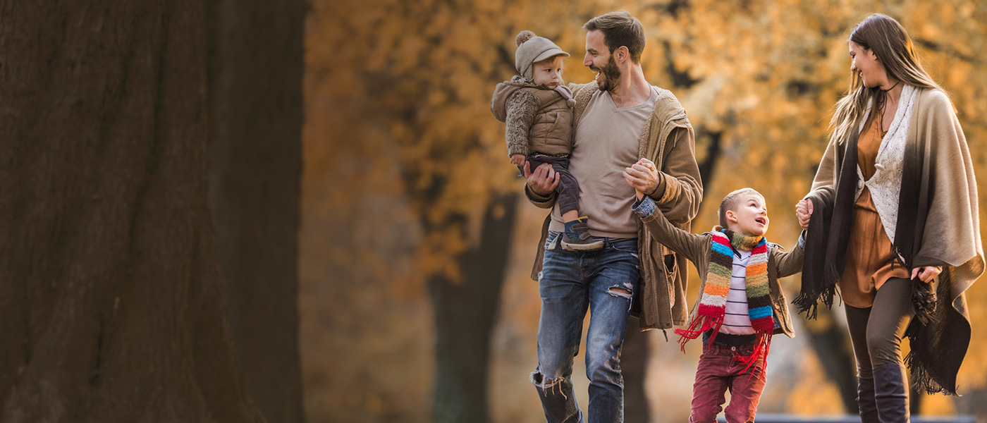 Happy family walking in woods care free covered with Forester Life Protection Plan