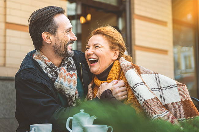 Happy couple with a coffee and Foresters personal insurance
