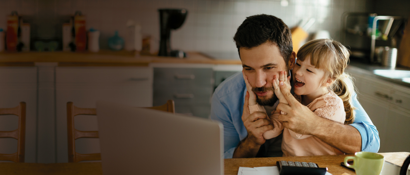 Father looking at Foresters financial tools and guides online with daughter
