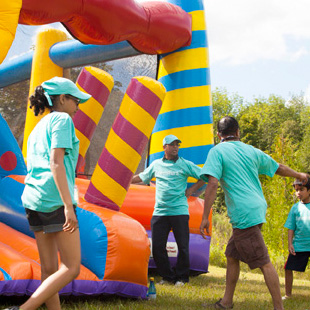 People playing beside bouncy castle