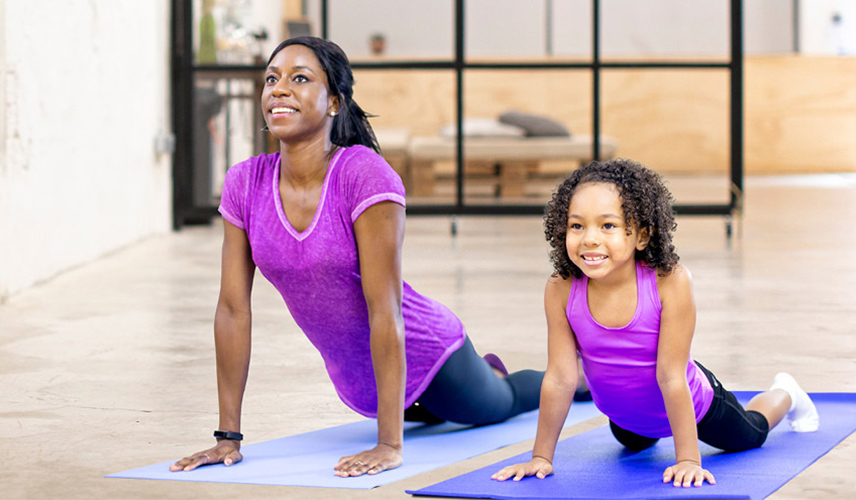 Mother and daughter doing yoga